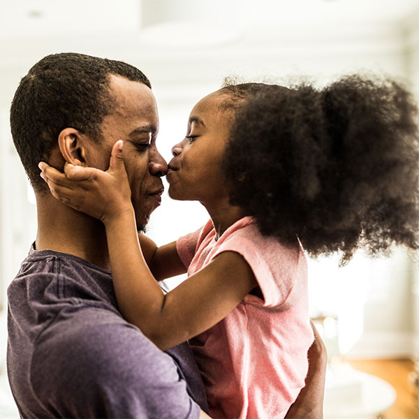 Father and daughter kiss on nose